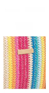 Detailed view of colorful woven texture and elegant gold metal plate on the crossbody bag