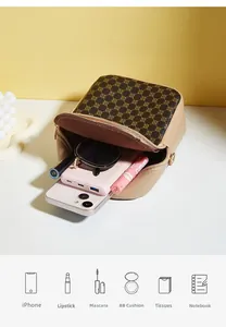 Detail view of a vintage cat crossbody bag showing capacity for phone and cosmetics