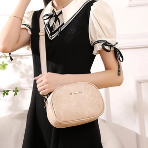 Minimalist beige oil wax leather crossbody bag with gold logo and wide shoulder strap