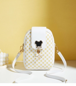 Detail of white mobile phone crossbody bag with yellow circle pattern and star charm