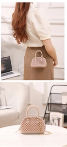 Detail of nude pink jelly shell bag with 3D beaded texture and golden chain strap
