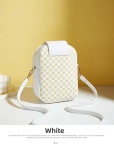 Detail of white pebbled leather phone bag with yellow pattern and gold hardware