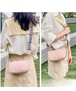 Vue lifestyle de sac à bandoulière matelassé rose avec sangle tissée à motifs