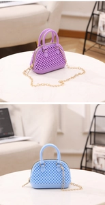 Detail of blue and purple mini jelly shell bags with pearl texture and gold chains