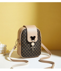 Detail of cross-body phone bag with Mickey silhouette metal ornament and star charm