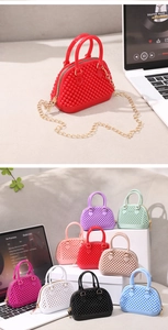 Macro view of shell-shaped jelly bag with fine pearl texture and metal chain strap