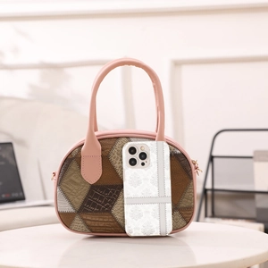 Pink handle plaid patterned tote bag with leather patchwork on white round table