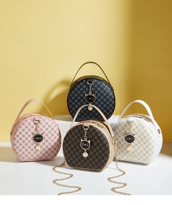 Group shot of colorful round bags with monogram patterns and cat-shaped metal charms