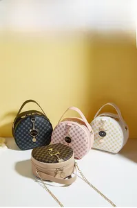 Detail of four colorful printed round handbags with golden chains and cute cat-ear charms
