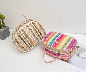 Detail of woven crossbody bag showing natural straw textures and leather handle details