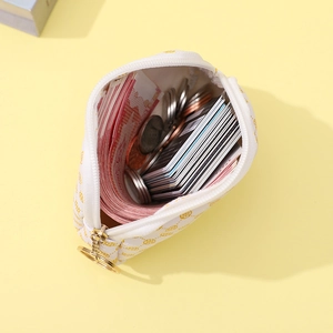 Minimalist small zipper pouch with yellow floral print and gold ring pull for cards and coins
