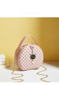 Pink round crossbody bag with geometric patterns and a cute black cat metal pendant