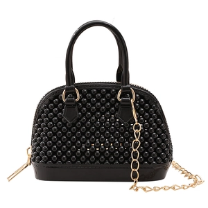 Mini black beaded shell jelly bag with glossy finish and gold chain crossbody strap