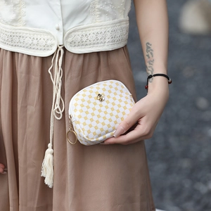 Minimalist mini floral zip pouch for women held by model for elegant lifestyle view