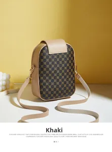 Detail shot of khaki crossbody phone bag with circular patterns on a minimalist setup