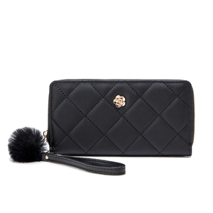 Long black quilted leather wallet for women with golden flower logo and pompom charm