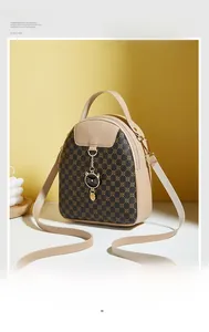 Detail view of mini monogram backpack with cat charm and adjustable straps