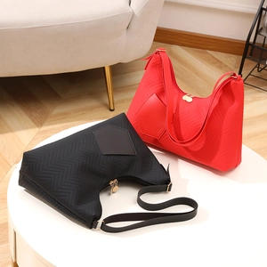 Chic quilted tote bags in red and black with wavy stitching and gold hardware