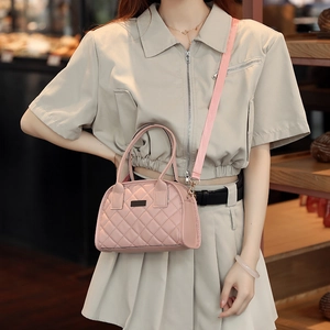 Pink quilted crossbody bag with textured faux leather and adjustable shoulder strap