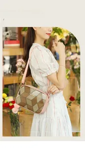 Detail of 3D geometric pattern on a crossbody bag with pink leather trim and zipper