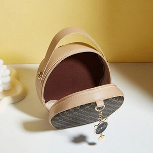 Retro khaki round leather bag with geometric patterns and a cute cat pendant