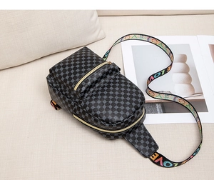 Black crossbody sling bag with circular patterns and a colorful LOVE printed strap