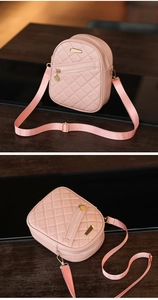 Detail view of pink quilted PU leather crossbody bag with golden zippers and strap