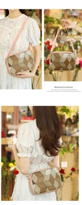 Close-up of pink crossbody bag with geometric pattern and golden logo details