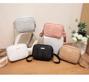Group view of quilted crossbody bags in five colors with wide adjustable straps