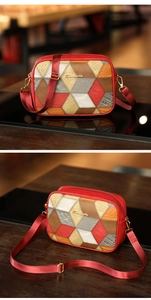 Detail view of red quilted crossbody camera bag with snakeskin texture and nylon strap