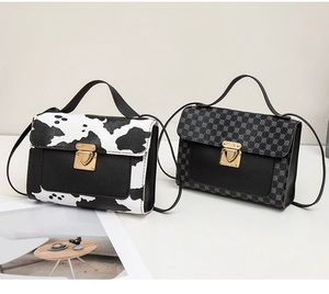 Détail de sacs bandoulière à motif vache et géométrique avec fermoirs cœur dorés