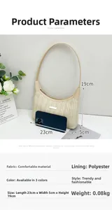 Detail view of woven straw shoulder bag with dimensions and light leather handle