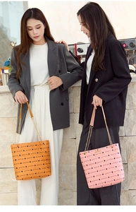 Dual view of quilted leather tote bags in orange and pink with gold chain straps