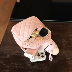 Pink quilted crossbody bag showing large capacity for phone, lipstick, and umbrella