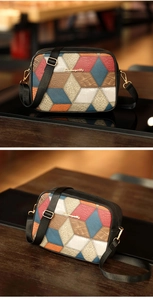 Close-up of geometric color-block patchwork camera bag with gold logo and wide strap