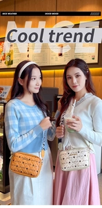 Quilted crossbody camera bags in tan and cream with lettered wide straps