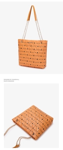 Detail of orange quilted tote bag with Luck For You print and metal chain strap