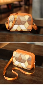 Detail of checkered crossbody camera bag with orange geometric patchwork and golden logo