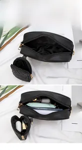 Detail of black wave quilted two-piece bag set showing interior storage and round charm