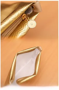 Detail of smooth zipper and white fabric lining on golden wavy pattern envelope bag