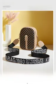 Detail of vintage patterned crossbody bag with wide jacquard strap and metal hardware