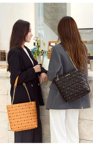 Detail of printed quilted tote bags with chain straps and Luck For You logo typography