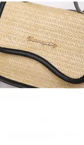 Close-up of straw saddle bag with black leather trim and golden Serendipity logo