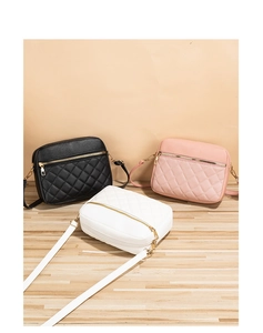 Detailed view of quilted faux leather crossbody camera bags in black, pink and white options
