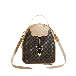 Women's small brown leather backpack with cat charm and floral print pattern