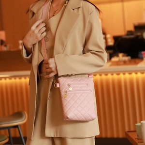 Pink quilted crossbody bag with dual gold zippers and adjustable strap for women