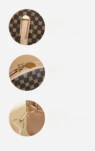 Detail of gold metal zipper and detachable shoulder strap hook on vintage floral handbag