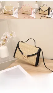 Detail of minimalist straw woven square bags with metal turn-lock and leather trim