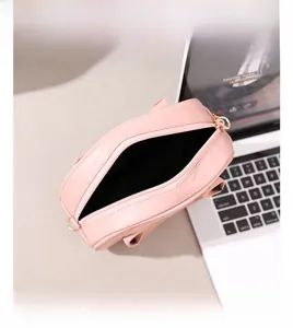 Interior view of pink quilted handbag showing storage space for phone and essentials