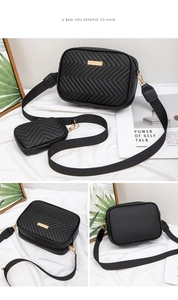 Detail of black quilted crossbody bag set with gold hardware and removable coin pouch